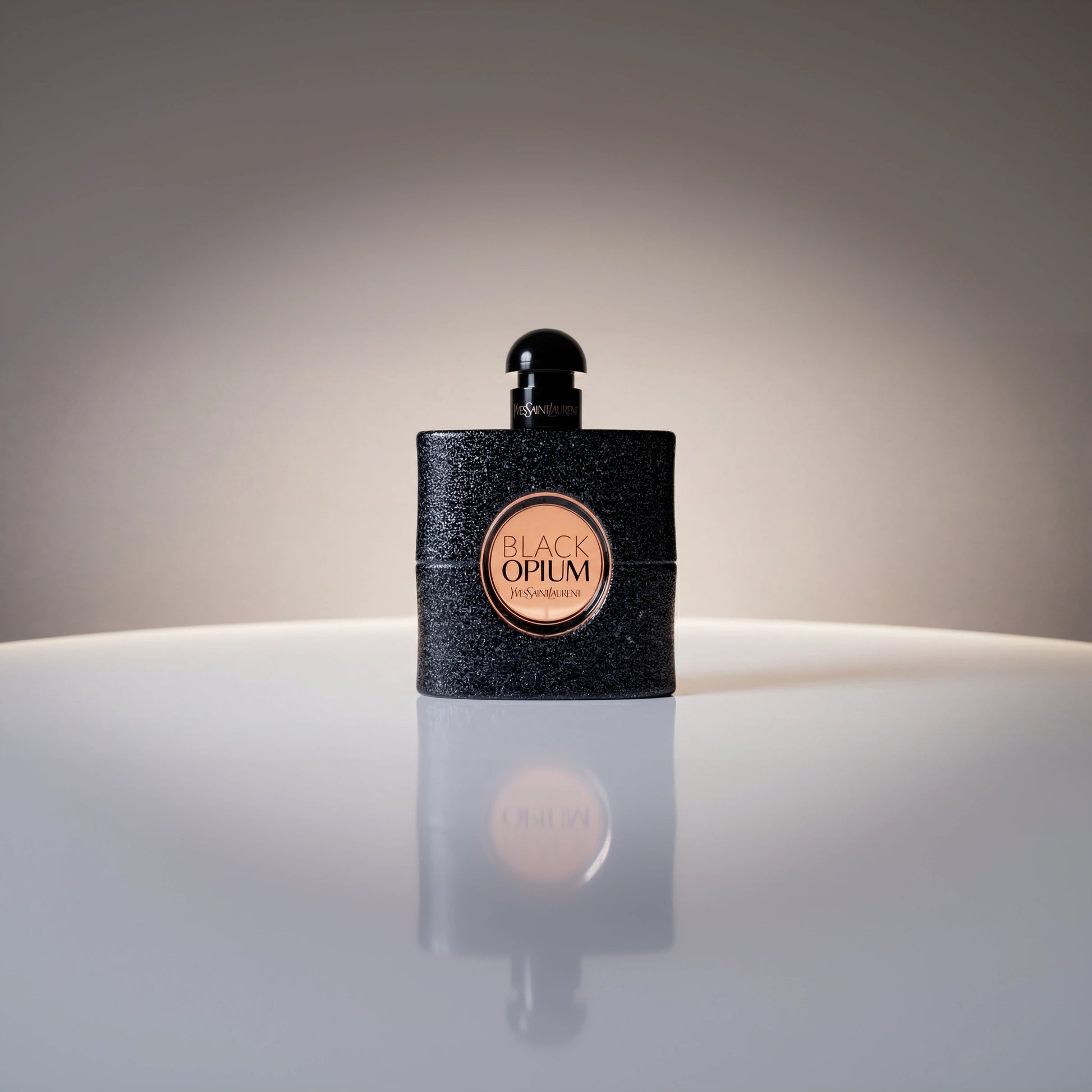 Yves Saint Laurent Black Opium Eau de Parfum Flakon mit eleganter Spiegelung auf hellem Untergrund.